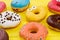 Background of multicolored glazed donuts.