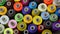 Background of multicolored spools of thread for a sewing machine and overlock