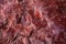 Background of natural stone texture of red brown rough granite. Piece of stone with textured pattern, cracks and