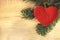 Background of the New year. Background with spruce branches and a Christmas toy in the form of a heart. For a new year or