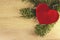 Background of the New year. Background with spruce branches and a Christmas toy in the form of a heart. For a new year or