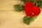 Background of the New year. Background with spruce branches, Christmas toy in the form of a heart and a wedding ring. For a new