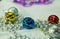 Background from New Year`s decorations. Silvery beads and colorful bells. Selective focus