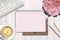 Background with a notebook for writing, pink shades, beautiful table interior with a flower