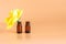 Background of the old board yellow flower rose in a small bottle on orange background two glass bottles