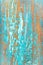 Background of old cracked wood painted in turquoise and orange colors. The background is out of focus around the perimeter of the