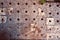 Background of old darkened scuffed and scratched gray concrete floor with remnants of floor tiles and rust