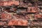Background of old rough concrete plaster and red brick brickwork closeup