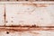 Background from an old rusty sheet of metal with faded rough frayed white paint