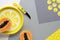 Background with papaya, exotic fruit, knife and leaves. Illuminating Yellow, Ultimate Gray, colors of the year 2021