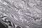 Background with pattern of damask steel. Close up. Macro shot of a damascus knife blade texture. Damascus steel pattern. Metal and