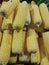 background photo of piles of sweet yellow corn at a traditional market