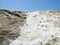 Background of pile of natural salt collected in saline on volcanic rock under blue sky. Ecosystem in extinction