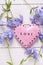 Background with pink decorative heart and fresh tender blue fl