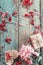 Background with pink peony, peonies petals, gift box and a wooden heart on old green boards.