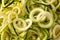 Background of Plain Zucchini Noodles an Alternative to Grain Pastas