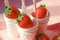 background portioned strawberries in cups