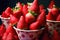 background portioned strawberries in cups