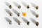 Background of quail eggs on white, one broken, with yellow yolk. Easter concept