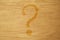 Background. Question mark painted on wood. Light brown. Place for text