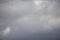 Background of real heavy clouds. Background summer sky. Gray background. Gray sky background with tiny clouds