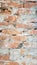 Background of red brick wall near pattern texture. A sample photo of a vertical wall with bricks and cement. Vertical photo for