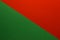 Background of red and green paper divided diagonally. Sheets of blank green and red paper with fine texture, close up