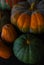 Background of red and green pumpkins on dark wood