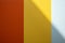 Background of red, yellow and gray colors with a shadow. Colored vertical stripes of different widths. Copy space.
