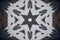 Background from a repeating kaleidoscope view with gray dark and bright lines and shapes coming from the center