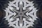 Background from a repeating kaleidoscope view with gray dark and bright lines and shapes coming from the center