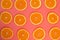 Background of ripe oranges cut on pink background