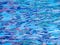 Background of rippled blue water in swimming pool.