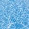 Background of rippled pattern of clean water in a blue swimming