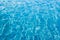 Background of rippled pattern of clean water in blue swimming po