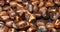 Background of roasted chestnuts just grilled roasted for sale