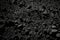 Background of rough, grainy stone or sand in black or dark gray