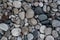 Background of round and oval stones without sharp edges. Stone texture. Sea shore. Rocky beach
