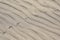 Background of sand, wind formed relief, bird footprints