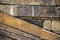 Background of sandstone rocks stacked with some on a diagonal and some horizontal - variety of colors and textures