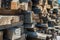 Background of sawn wooden slab, sawn boards, sawn logs receding into the distance. pile of different shaped and size timber pieces