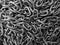 Background of shiny metal chains. Links are randomly. Top view. Close up. Black and white image.