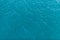 Background shot of aqua sea water surface. Sea surface aerial view. Waving water surface of the sea background