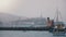 Background shot of famous Alcatraz island and former prison in San Francisco, beautiful summer cruise boats and pier.