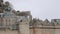 Background shot of French flag waving on majestic ancient Mont Saint Michel, famous island fortress town slow motion.