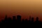 Background of silhouettes of skyscrapers. Modern vector landscape. Modern city, houses, skyscrapers. Dark silhouette of buildings