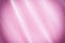Background with a silk texture. Beautiful fabric is bright pink with folds.