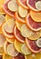 Background from slices of orange of different varieties and lime. Vertical