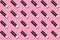Background of small tubes of lipstick on a pink background.