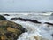 Background soft wave of Sea with foam on sandy beach, copy space.beach rocks backbround.
